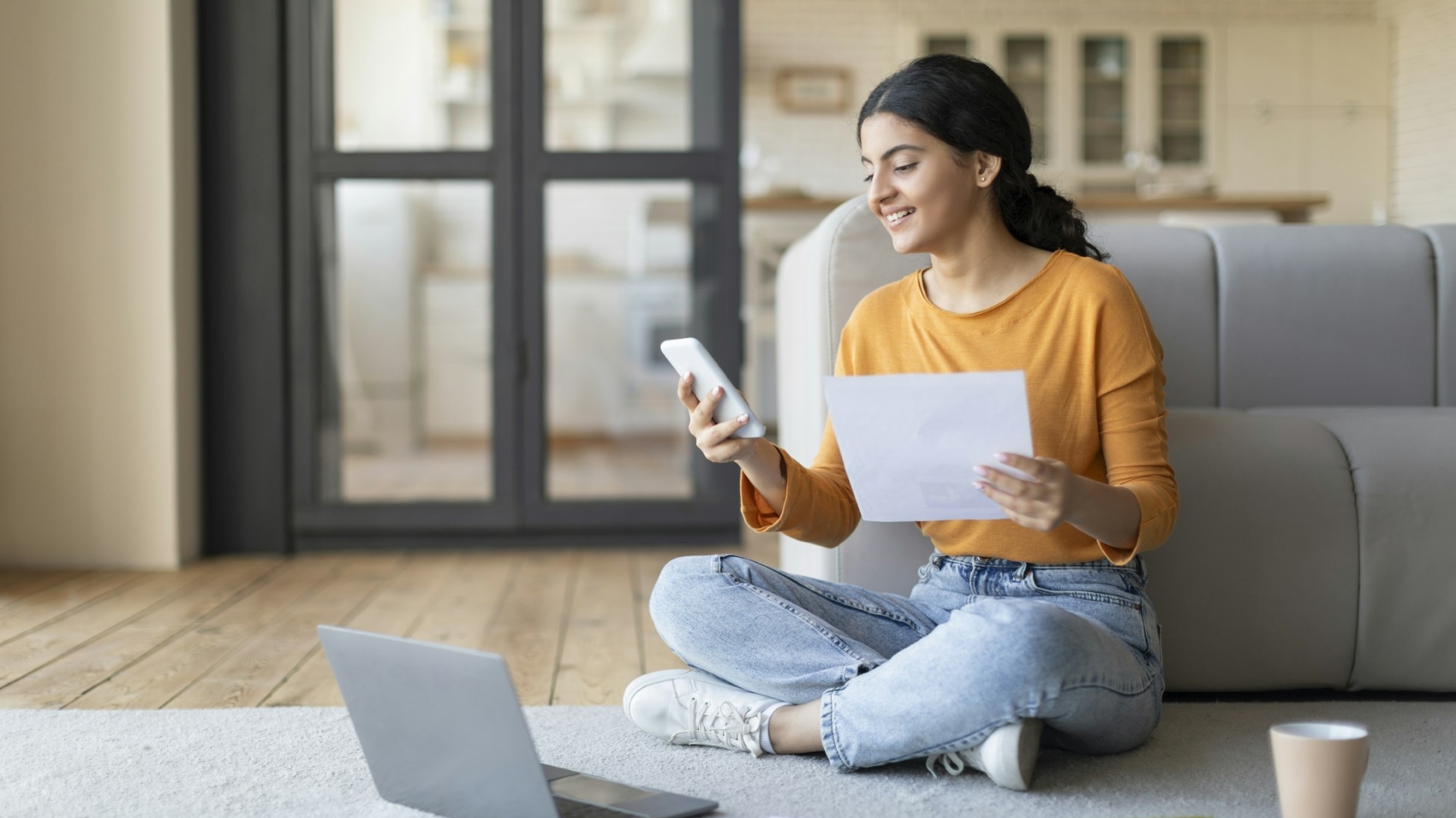 Young Indian Female Working With Laptop And Smartphone At Home
