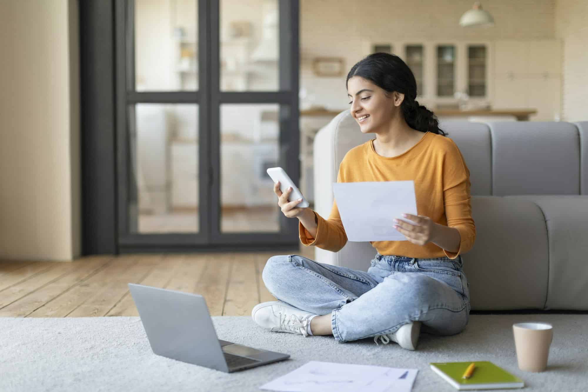 Young Indian Female Working With Laptop And Smartphone At Home